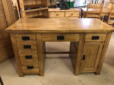 Modern light wood desk with six drawers and one cupboard, approx 136cm x 60cm x 80cm tall