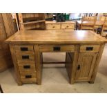 Modern light wood desk with six drawers and one cupboard, approx 136cm x 60cm x 80cm tall