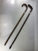 Two wooden walking canes with hallmarked silver collars