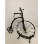 Antique Penny Farthing on original stand with leather seat, approx 87cm tall