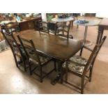 Ercol dining table and six ladder back chairs (two carvers) with detachable cushions, table approx