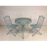 Round metal garden table, approx diameter 75cm, with two matching folding garden chairs, painted