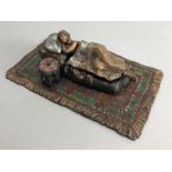 Cold painted bronze of a nude sleeping lady in a bed on a carpet, approx 16cm in length