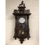 Vienna style eight day spring driven striking clock in mahogany case with rearing horse pediment,