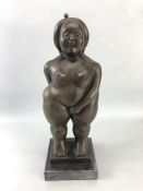 After Botero, a figurine of a rotund lady with eyes closed, approx 37cm tall, mounted on black