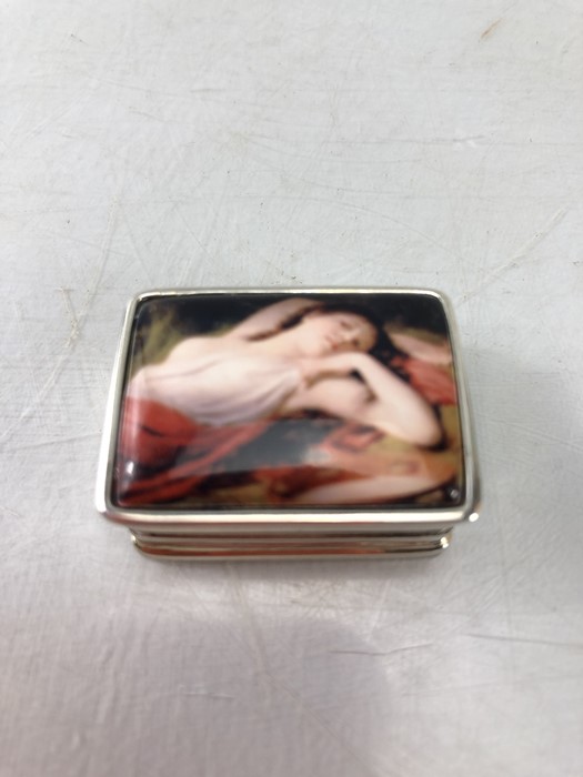 Small rectangular silver pill box with recumbent lady to lid. Stamped 925