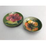 Moorcroft green hibiscus pattern dish, approx 11.5cm in diameter and a Moorcroft orange hibiscus