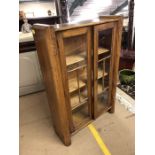 Display cabinet / book shelf with two glazed doors and carved detailing to top, approx 77cm x 25cm x