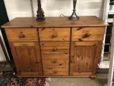 Pine sideboard on bun feet with six drawers and two cupboards, approx 116cm x 43cm x 81cm tall