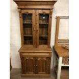 Pine dresser with glazed two door shelved cupboard over and two door cupboard under, with carved