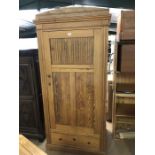 Antique pine single wardrobe with drawer under, hanging rail and panelled detailing to door,