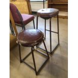 Two vintage leather-topped industrial-style stools, tallest approx 73cm in height
