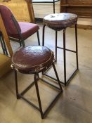 Two vintage leather-topped industrial-style stools, tallest approx 73cm in height