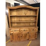 Large pine kitchen dresser with three drawers and cupboards under, approx 154cm x 51cm x 190cm tall
