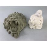 Plaster cast of a lions head painted green and a small seated buddha statue