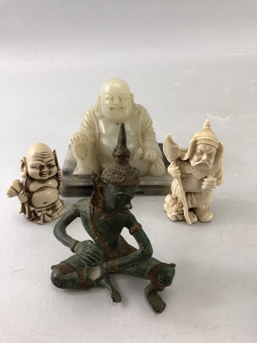 Four oriental items to include Netsuke, seated Buddha and a metal Thai Deity