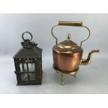 Copper and brass kettle on stand along with a vintage lantern with glass panels and hinged door