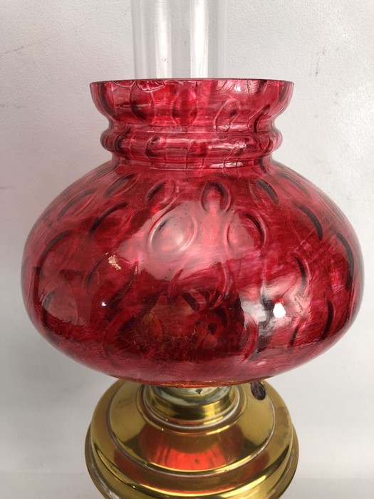 Brass based oil lamp with chimney and cranberry shade - Image 2 of 4