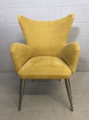 Contemporary yellow-upholstered wingback armchair on tapering chrome legs, approx 65cm wide x 58cm