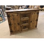 Mexican pine sideboard with two cupboards and three drawers, approx 125cms x 52cms x 87cms tall