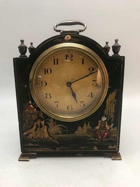 French small wooden carriage clock with brass finials and feet and a gold starburst face, the wooden