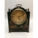 French small wooden carriage clock with brass finials and feet and a gold starburst face, the wooden
