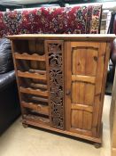 Carved wooden wine rack with single cupboard