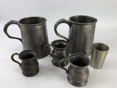 Five pewter cups and a measure, the largest approx 11cm tall