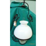 Metal framed hanging oil lamp with clouded glass shade and yellow and white mottled bowl