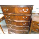 Bow fronted mid 20th century chest of 5 long drawers with brass drop handles on bracket feet