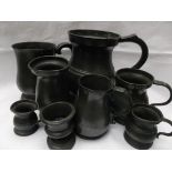 Selection of 8 pewter tankard measures one quart to one quarter gill