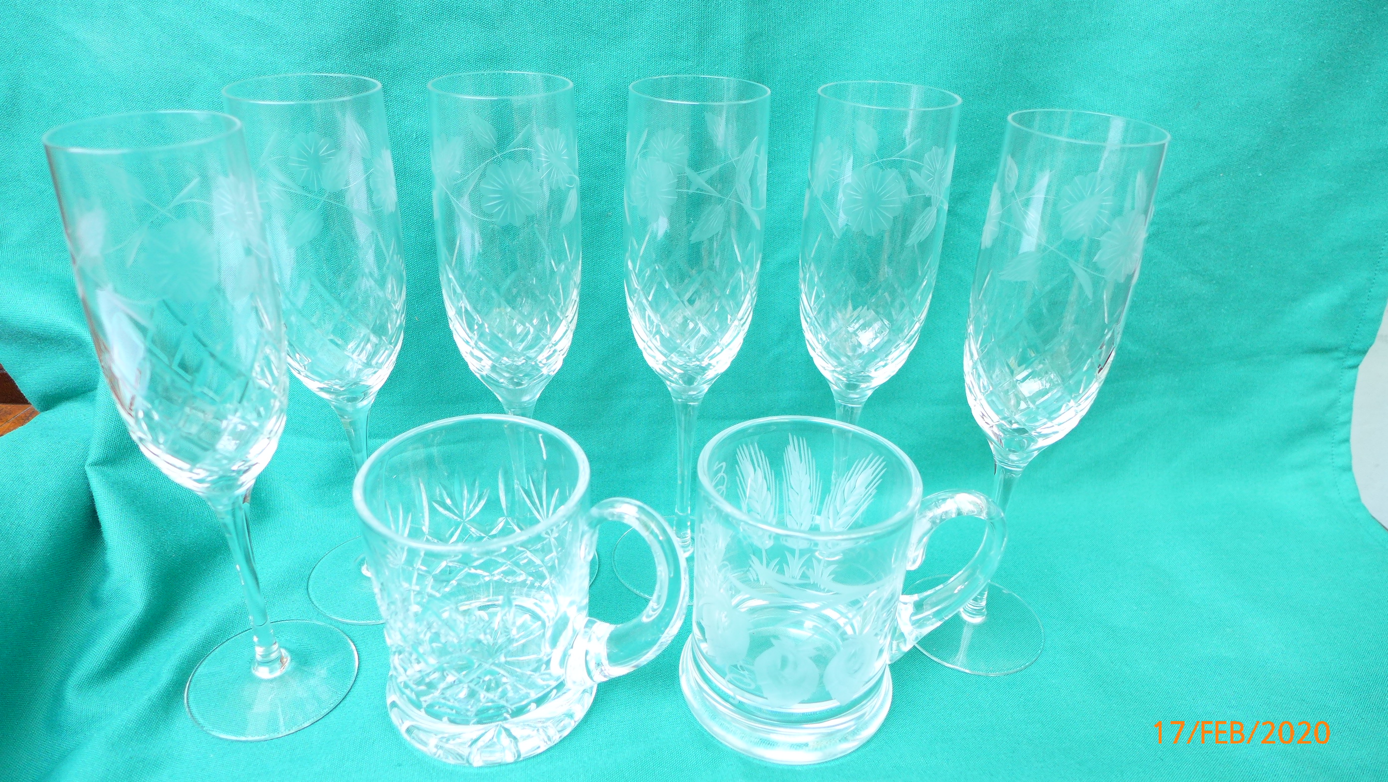6 etched glass champagne flutes and 2 cut glass edged ale tankards