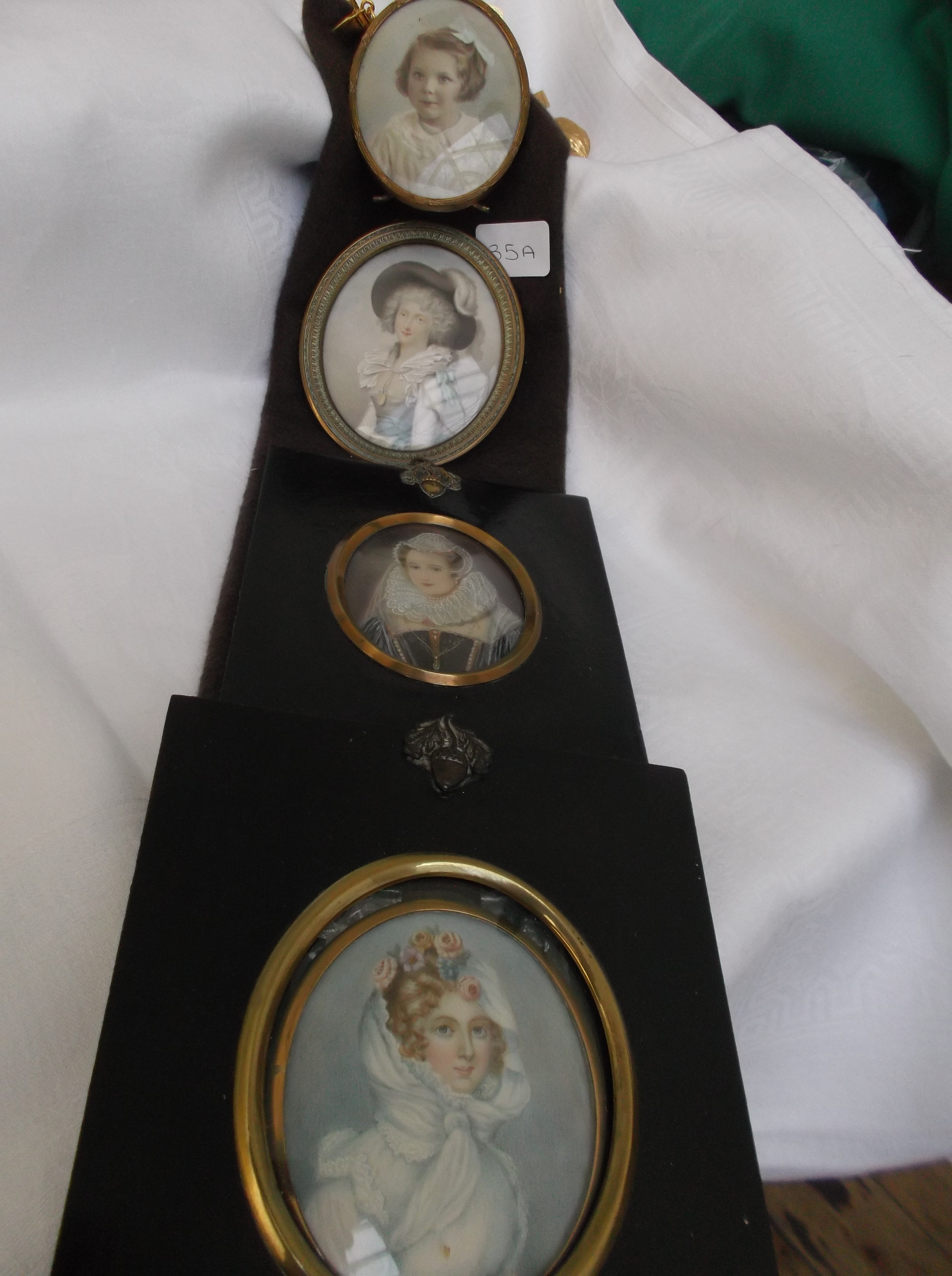 String of 4 miniatures, 2 in oval brass frames,