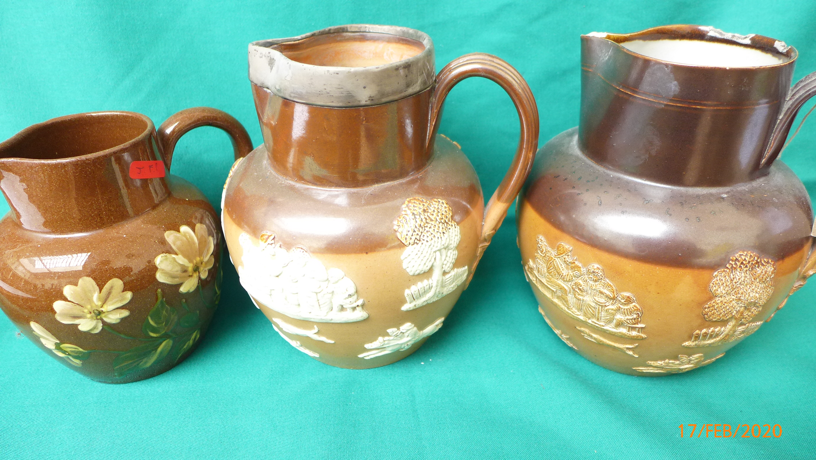 Early 20th century Royal Doulton brown stoneware water jugs with raised decoration,