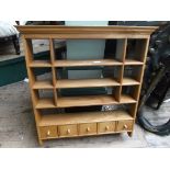 Polished pine wall display unit fitted open shelves and 5 small based cupboards