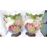 Pair of handled urn shaped mantelpiece vases decorated coloured pink and yellow roses