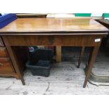 Mahogany fold over Victorian games table on plain tapering feet,