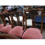 4 shaped backed Edwardian oak dining chairs, the carved back inset 3 vertical splats,