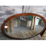 Large oval inlaid mahogany framed bevel edged mirror