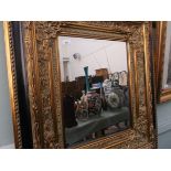 Ornate gilt framed bevel edged wall mirror