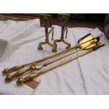 Set of brass fire dogs with 3 long handled fire irons