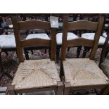 Pair of bold high backed rafia seated kitchen chairs each with 2 shaped horizontal splats to back