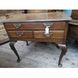 Oak lowboy of one long and 2 small drawers each with brass drop furniture on tapering shaped spud