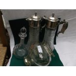 Pair of glass and plated handled claret jugs,