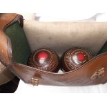 Pair of brown tyrolite lawn bowls with steel measure all in light brown plastic carrying case