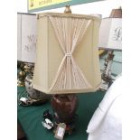 Mottled brown porcelain based table lamp with metal additions and beige parchment shade