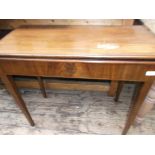 Mahogany fold over Victorian games table on plain tapering feet,