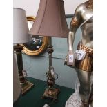 Metal based table lamp with pink parchment shade