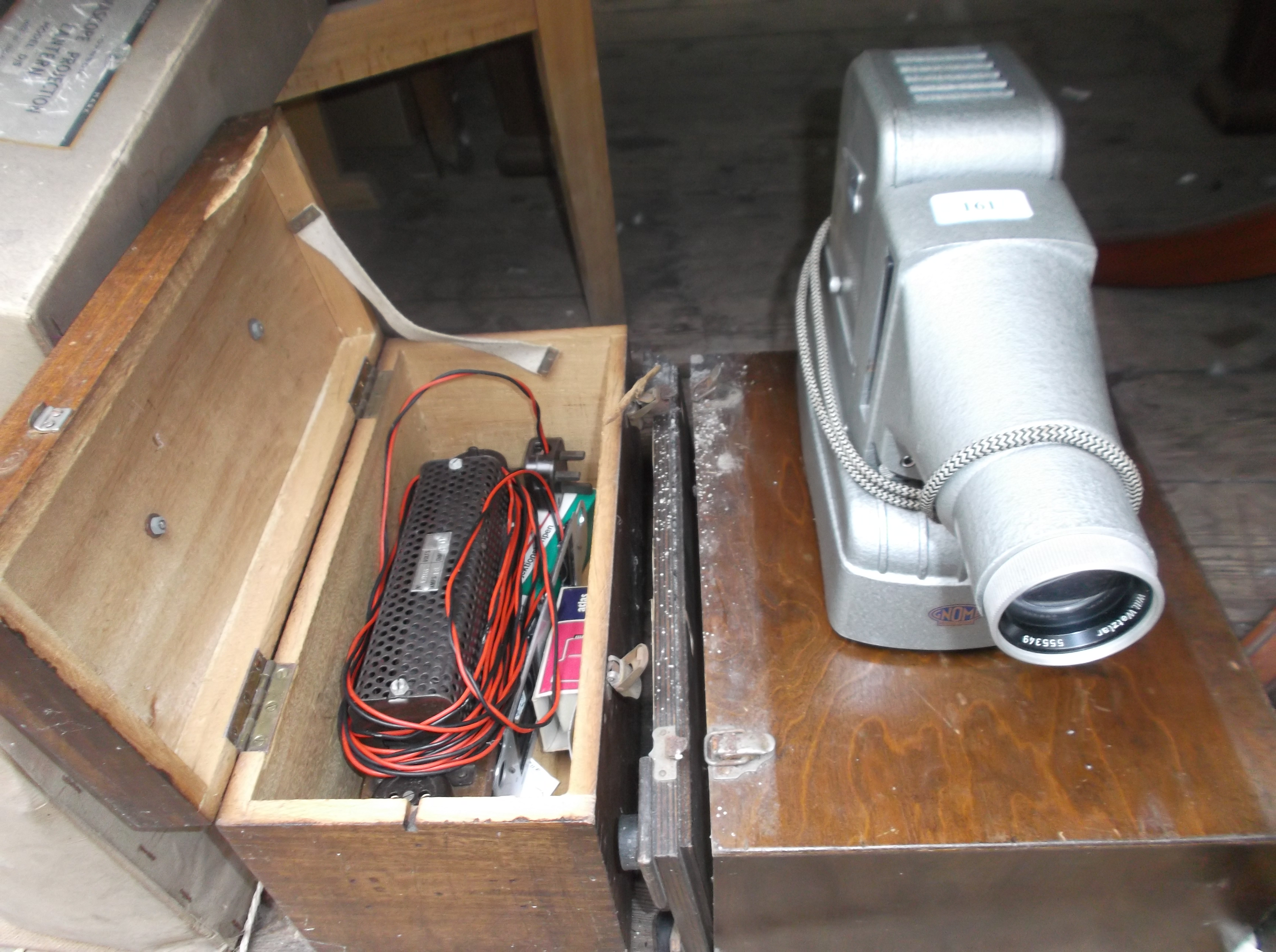 Knome projector in original case together with a boxed volt meter in original case