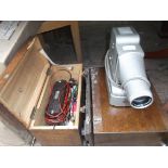 Knome projector in original case together with a boxed volt meter in original case